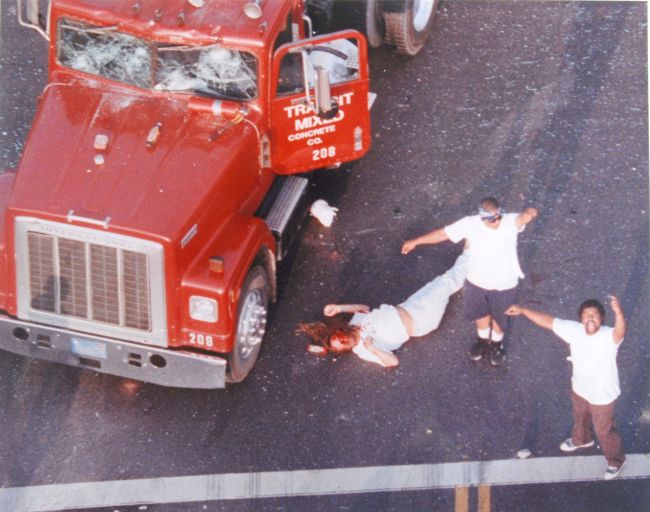 Rioters celebrate around Reginald Denny's body after the truck driver was pulled from his vehicle and beaten in the early hours of the Los Angeles riots. The photo, which was taken by Robert Clark from a news helicopter, ran on the front page of the Daily Breeze and was the only photo of this incident taken by a print photographer. It won the Gold Award for for Photojournalism from the Society of News Design. Photo by Robert Clark/Santa Monica Outlook