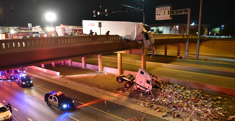 Trucker in serious condition after truck cab plunges off bridge