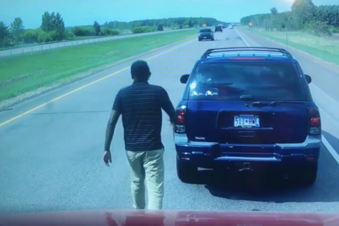 A trucker encounters a stuck motorist on the roadway in front of him.