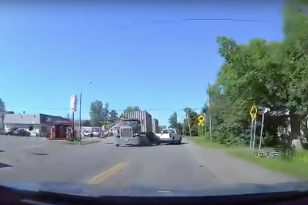 VIDEO: Oblivious pickup driver is just a hair away from being obliterated by a semi truck