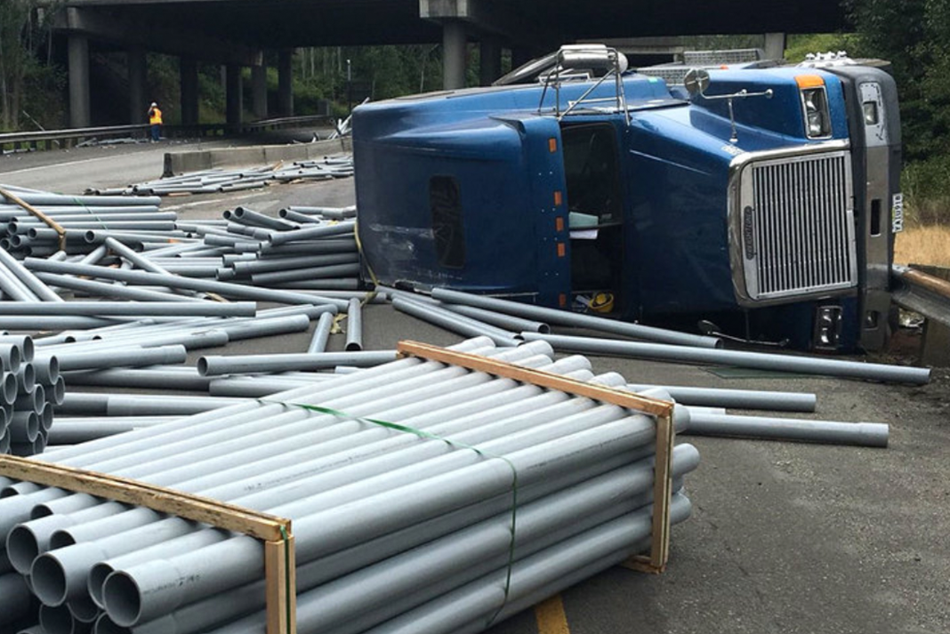 Trucker speeding around curve overturns semi and sends PVC pipe everywhere