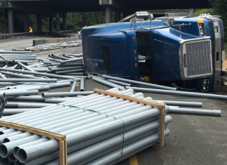 Trucker speeding around curve overturns semi and sends PVC pipe everywhere