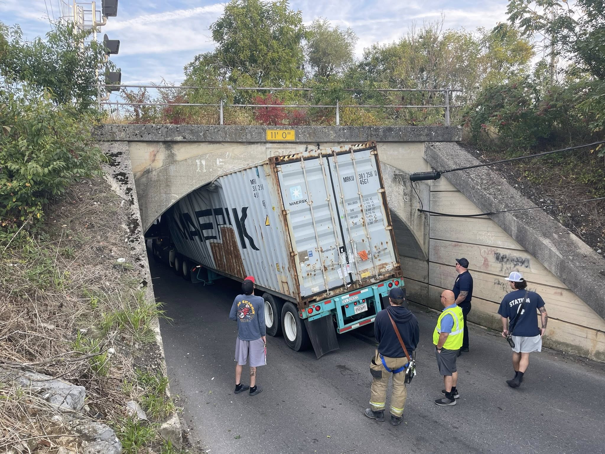 Tractor trailer CRUSHED trying to squeeze under low railroad bridge