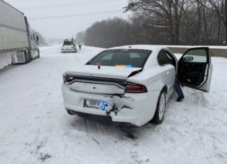 Indiana troopers say police cruiser was hit by TWO semi trucks on I-70