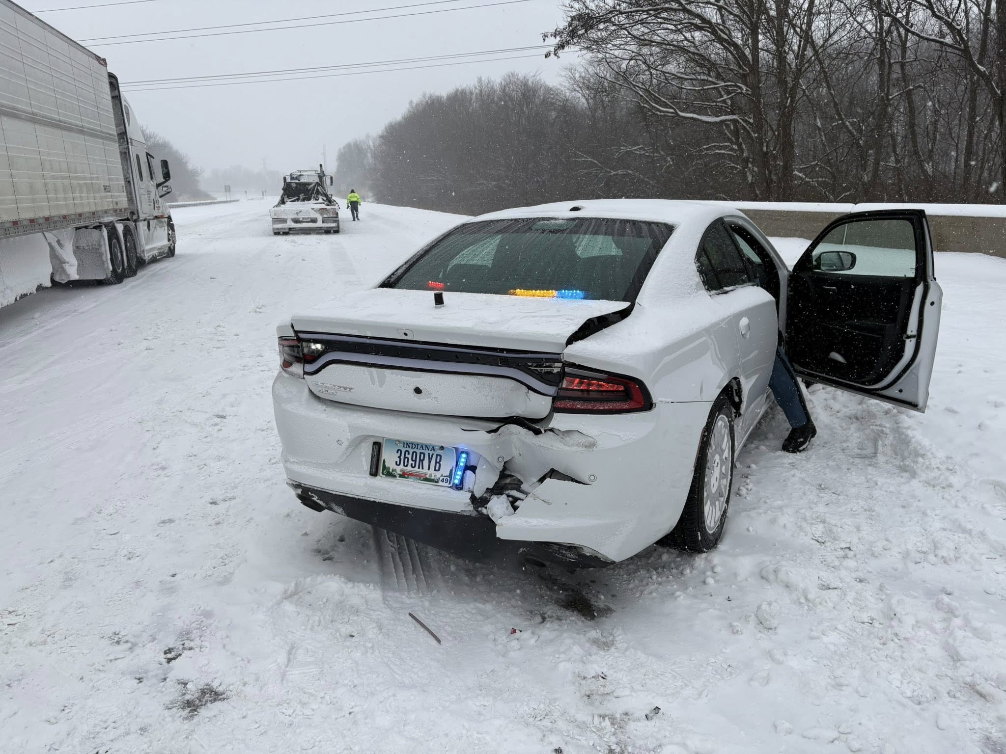 Indiana troopers say police cruiser was hit by TWO  semi trucks on I-70