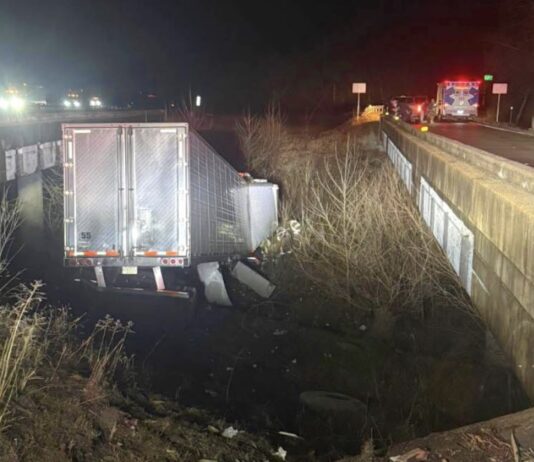Tractor trailer CRASHES off I-44, lands between bridges