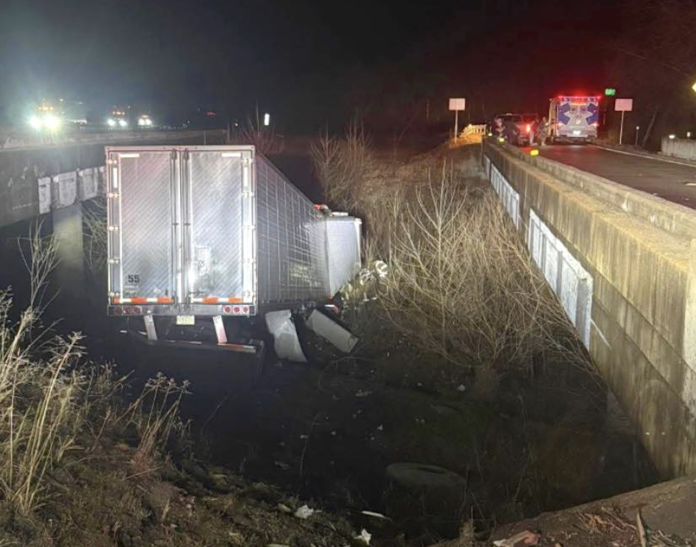 Tractor trailer CRASHES off I-44, lands between bridges