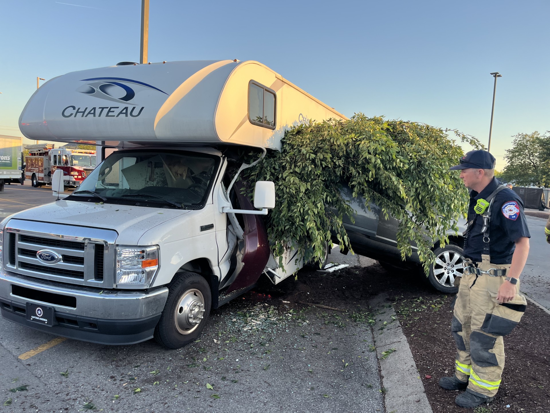 Tennessee firefighters respond to Kroger parking lot crash involving car, RV, and tree