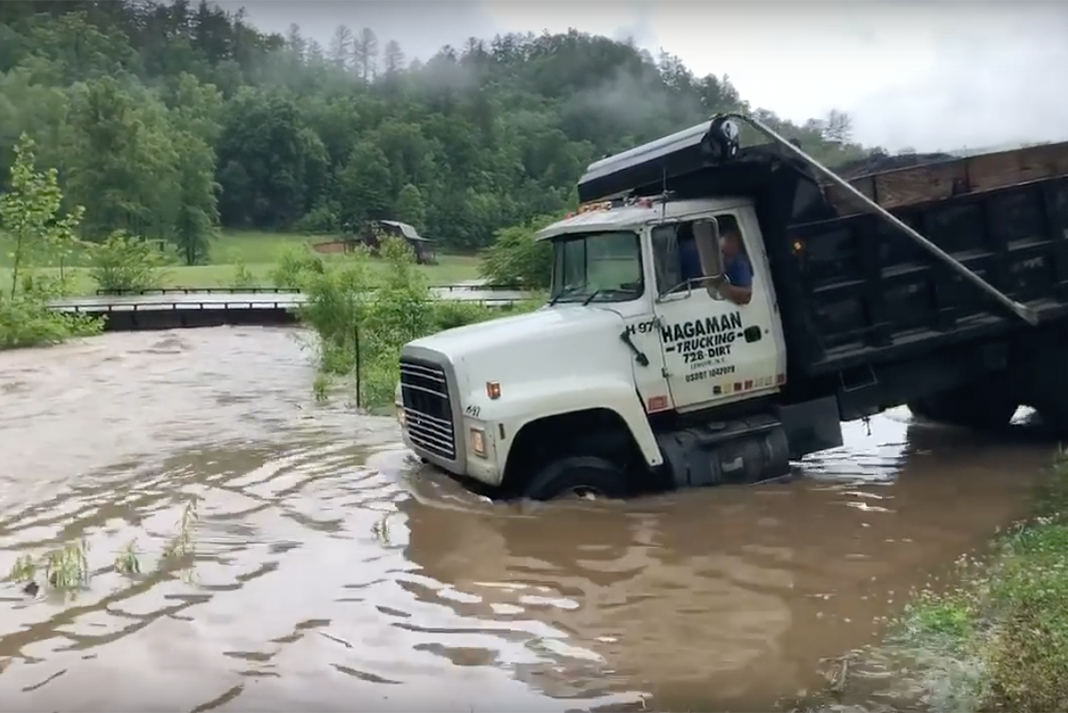 VIDEO: This dump truck driver ain’t about to let a raging creek stop him