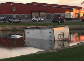 Boat-rescue launched after truck driver skids into pond