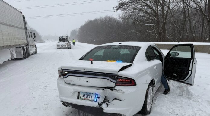 Indiana troopers say police cruiser was hit by TWO semi trucks on I-70