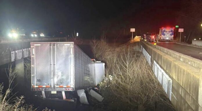 Tractor trailer CRASHES off I-44, lands between bridges