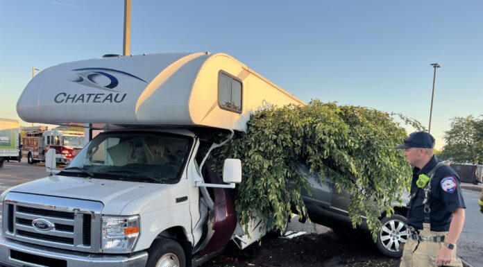 Tennessee firefighters respond to Kroger parking lot crash involving car, RV, and tree